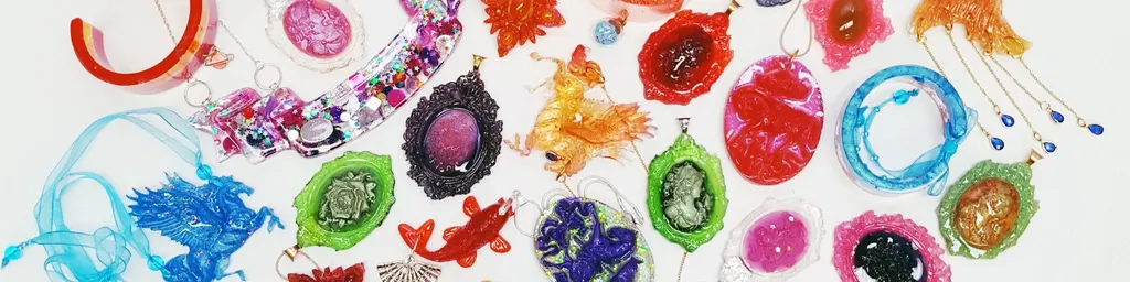 Radical Renaissance resin jewellery and objects spread out on white